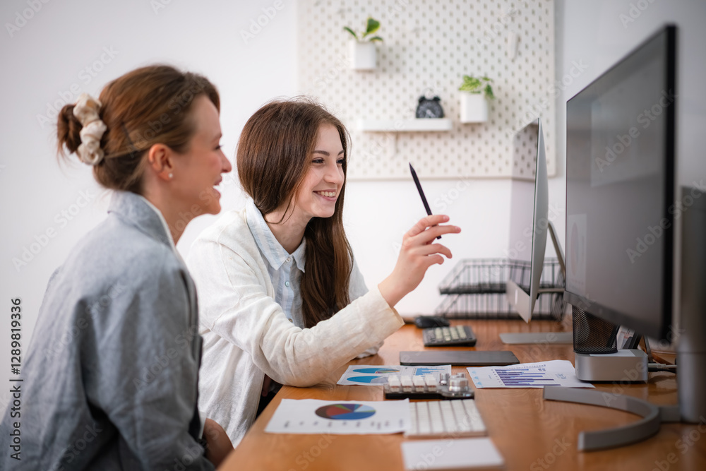 Two businesswomen discuss business planning in the office.