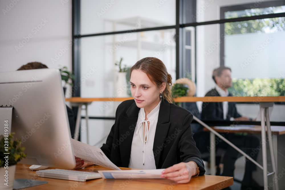 Businesswoman sitting and analyzing business performance in office