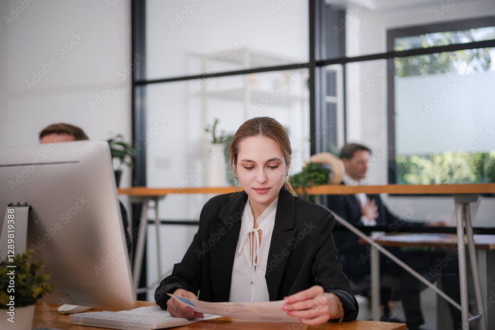 Businesswoman sitting and analyzing business performance in office