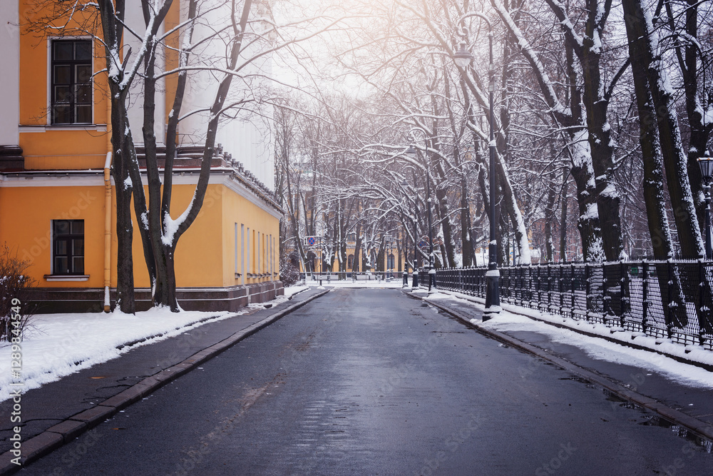 City street of the historical center after snowfall.