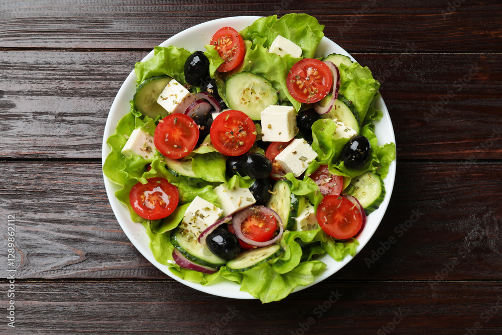 Delicious fresh Greek salad on wooden table, top view Delicious fresh Greek salad on wooden table, top view
