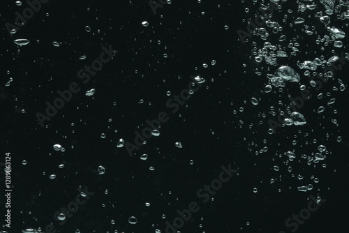 Many water bubbles on black background, closeup