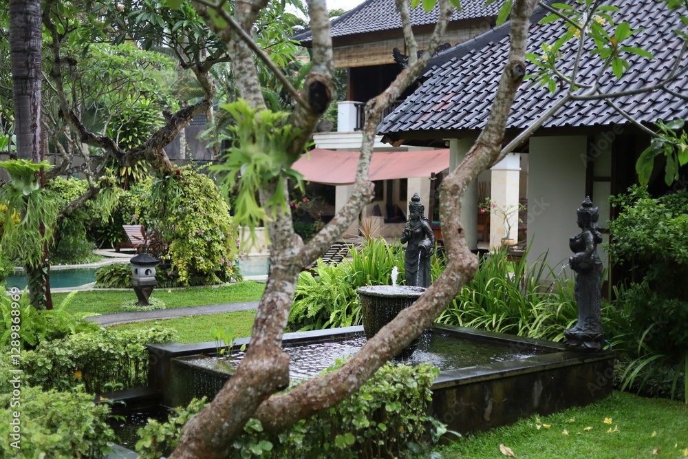 Traditional Balinese style garden with tropical plants, stone Balinese statues, and a decorative pond. Perfect for nature-inspired outdoor decor and tropical landscaping. Traditional Balinese style garden with tropical plants, stone Balinese statues, and a decorative pond. Perfect for nature-inspired outdoor decor and tropical landscaping.