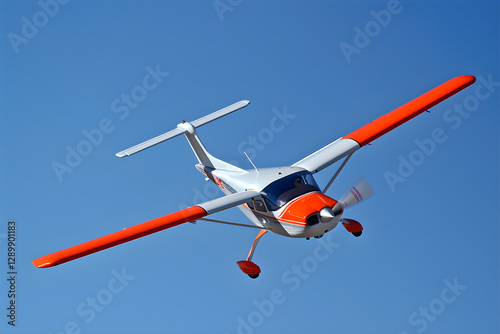 Dynamically Soaring Red and White RC Airplane Against Clear Blue Sky photo