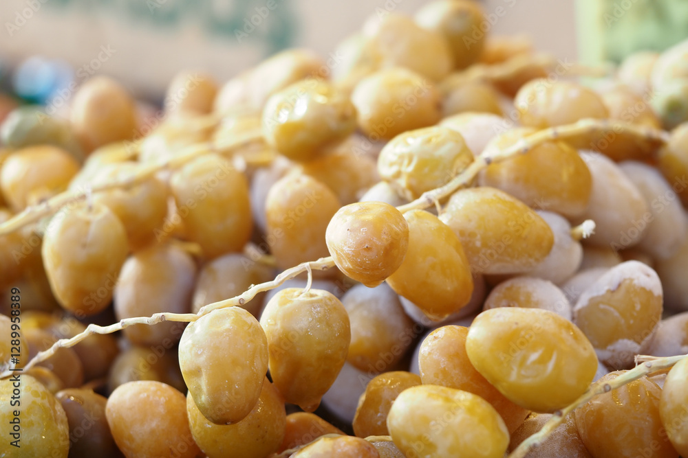 Fresh yellow dates at a bustling market in the afternoon sun Fresh yellow dates at a bustling market in the afternoon sun