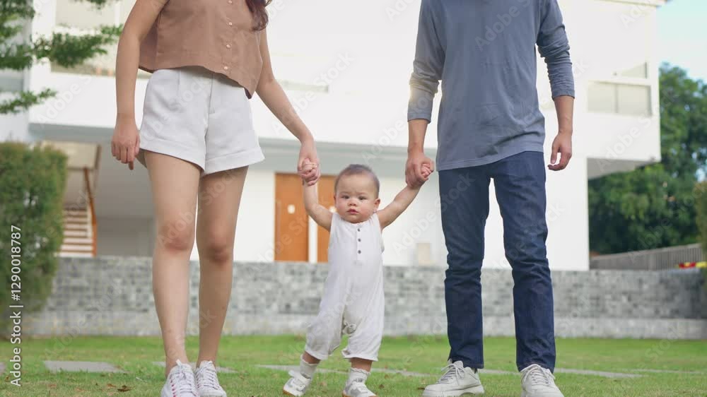 Close up of parents lovingly care for their baby boy outdoors in park. Close up of parents lovingly care for their baby boy outdoors in park.
