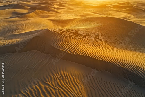 aerial photograph of pristine desert dunes creating hypnotic ripple patterns in golden sand during magic hour