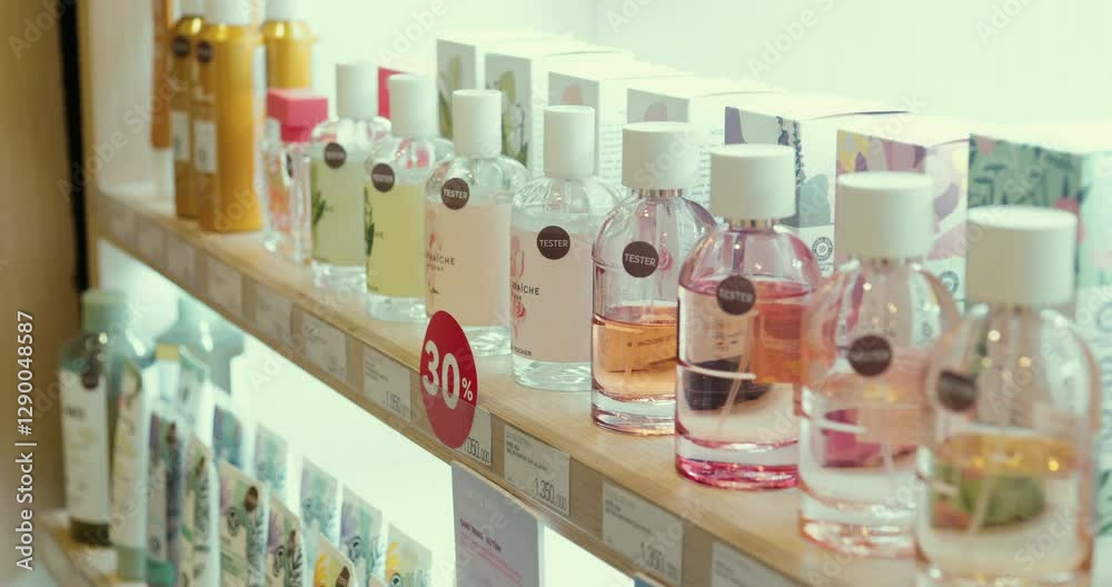 Perfume shopper testing fragrances, carefully sampling scents from store display while evaluating preferred fragrance selection Perfume shopper testing fragrances, carefully sampling scents from store display while evaluating preferred fragrance selection