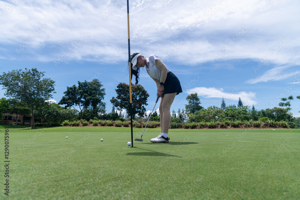 Obraz premium Professional woman golfer teeing golf in golf tournament competition at golf course for winner
