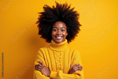 A Smiling African American Woman in a Cozy Yellow Sweater Against a Bright Yellow Background, Exuding Joy and Confidence photo