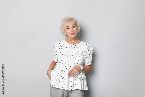 Obraz na plátně Portrait of elegant grandmother on light grey background