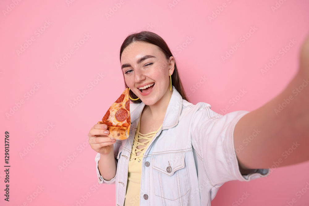 Beautiful woman with delicious pizza taking selfie on pink background, space for text Beautiful woman with delicious pizza taking selfie on pink background, space for text