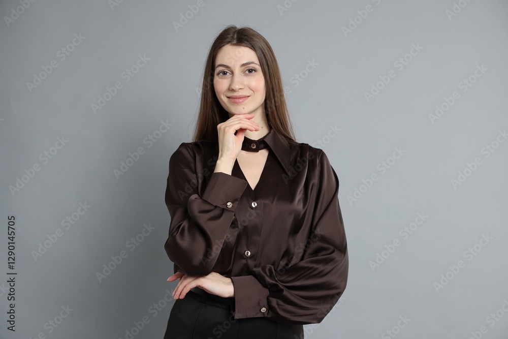 Beautiful woman in stylish outfit on grey background Beautiful woman in stylish outfit on grey background