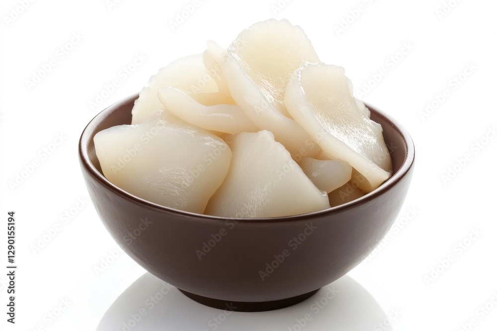 The image displays a brown bowl of sliced lotus root The image displays a brown bowl of sliced lotus root