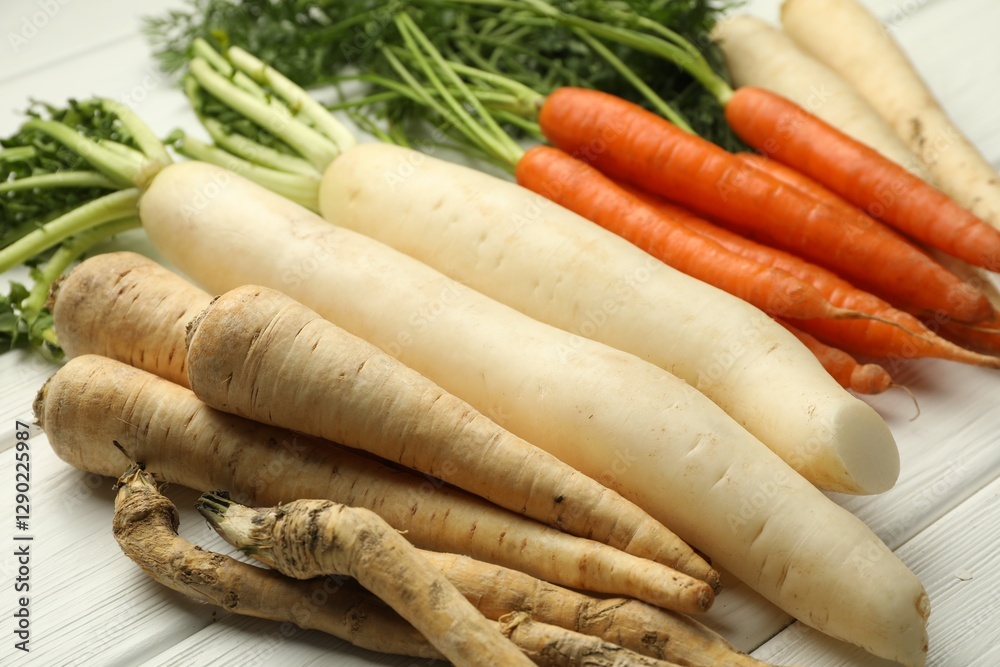 Different root vegetables on white wooden table, closeup Different root vegetables on white wooden table, closeup