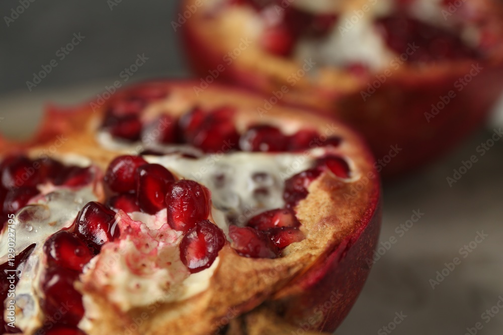 Fresh juicy pomegranates on grey table, closeup Fresh juicy pomegranates on grey table, closeup