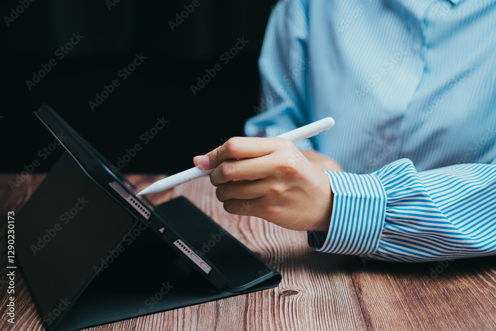 Person Using Digital Tablet with Stylus on Wooden Table, Business concept Person Using Digital Tablet with Stylus on Wooden Table, Business concept