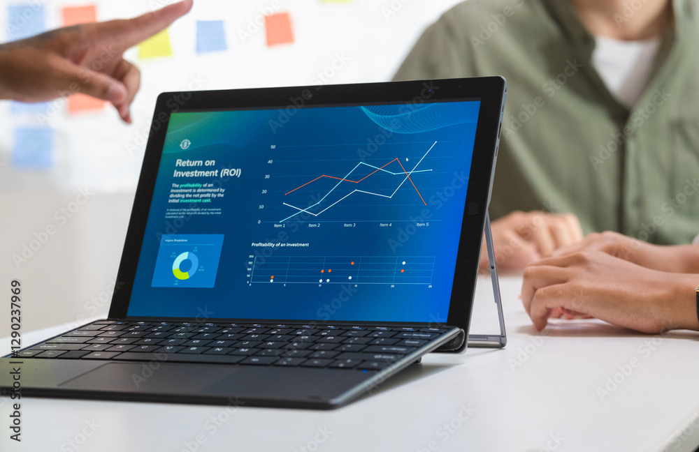 Fototapeta premium laptop when present business presentation in a dimly lit office, analyzing financial charts and data projections on a screen