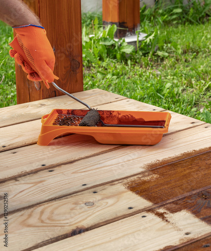 Wallpaper Mural Man is painting a wooden surface with a brush Torontodigital.ca