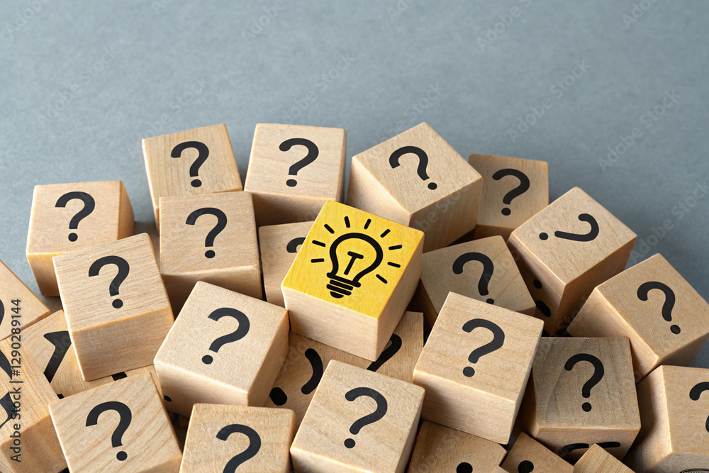 A collection of wooden blocks, arranged in a cluster, with numerous question marks printed A collection of wooden blocks, arranged in a cluster, with numerous question marks printed