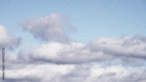 Floating Cumulus Clouds Under a Vibrant Blue Sky