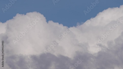 Floating Cumulus Clouds Under a Vibrant Blue Sky