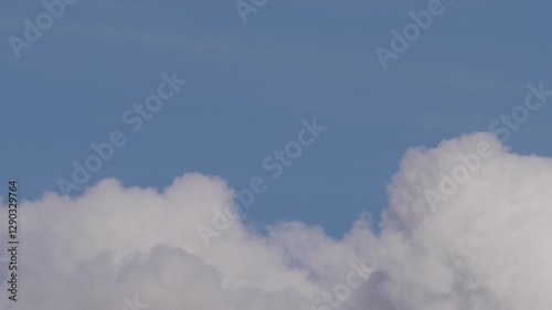 Floating Cumulus Clouds Under a Vibrant Blue Sky