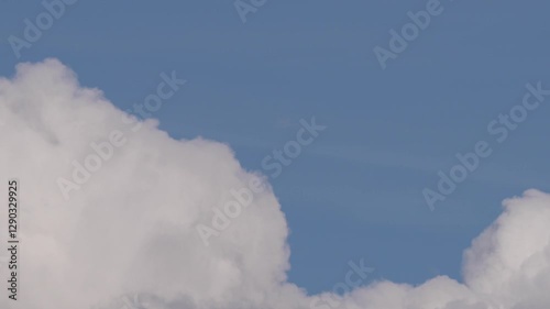 Floating Cumulus Clouds Under a Vibrant Blue Sky
