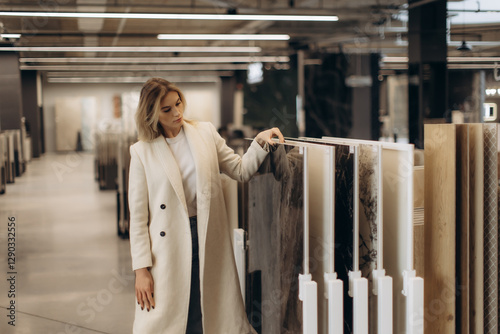 Woman Browsing Modern Interior Decoration Materials in a Showroom Setting