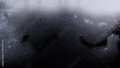 mysterious condensation pattern on dark glass with abstract shapes and water droplets, perfect for background and texture

