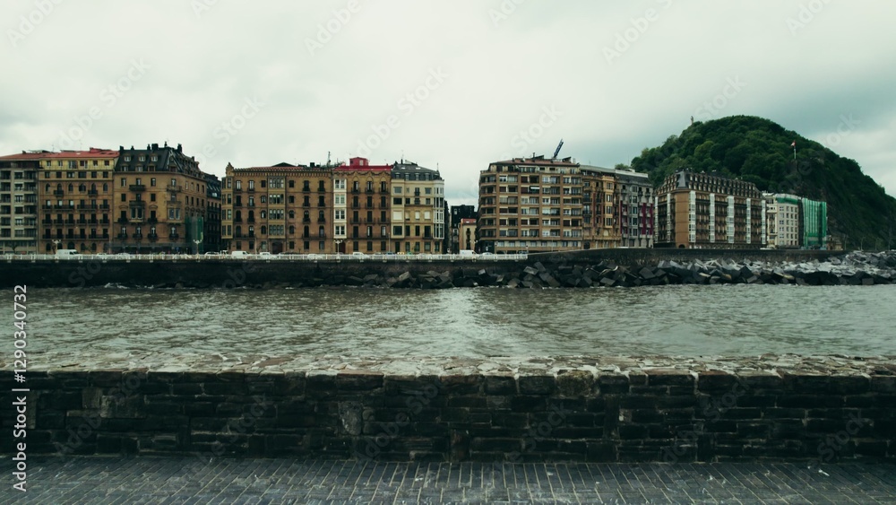 Fototapeta premium The drone flies along the sea bay passing among the European city with old houses along the coast