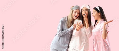 Young women in pajamas usin...
