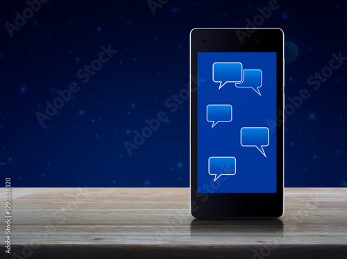 Social chat sign and speech bubbles on modern smart mobile phone screen on wooden table over fantasy night sky and moon, Social online network concept