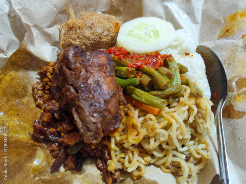 Nasi campur (Nasi Rames) is a typical Javanese Indonesian dish, which consists of white rice served with various side dishes. photo