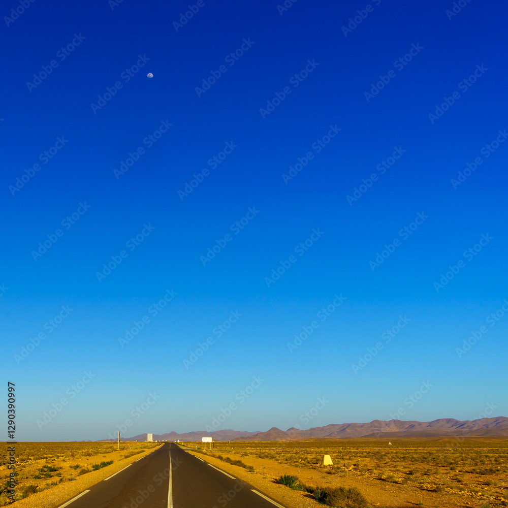 Desert road, with the Atlas Mountains