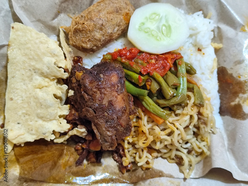 Nasi campur (Nasi Rames) is a typical Javanese Indonesian dish, which consists of white rice served with various side dishes. photo