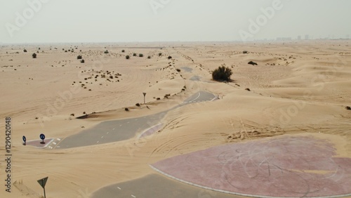 Photography The drone flies over a modern paved road with a roundabout covered with desert s