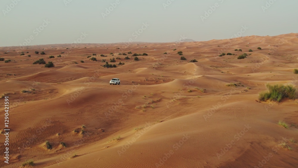 The car goes off-road on the sand dunes of the desert, drone video The car goes off-road on the sand dunes of the desert, drone video