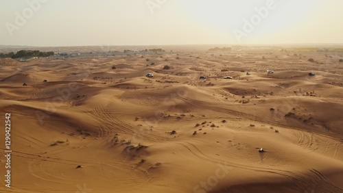 Canvas Print Cars driving off-road among sand dunes in the desert. Drone view