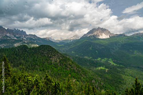 Obraz na płótnie Breathtaking view of forests, mountains, and valleys in the Italian Dolomites (Dolomiti, Dolomiten). Captured from a scenic trail along a rocky ledge. Stunning alpine nature w salonie