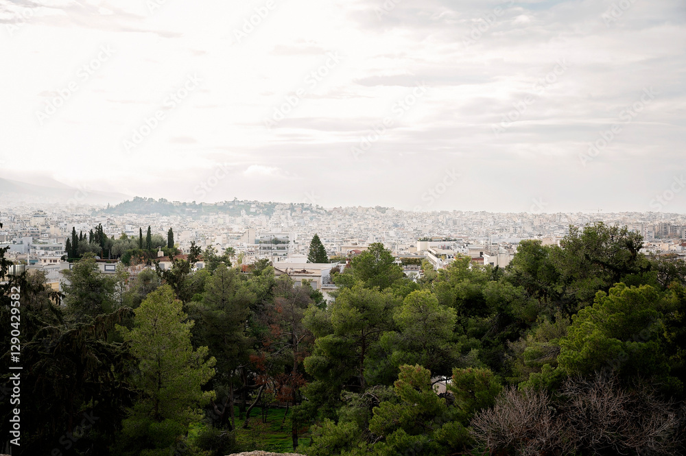 Fototapeta premium Panoramic view of Athens cityscape with greenery and historic ruins