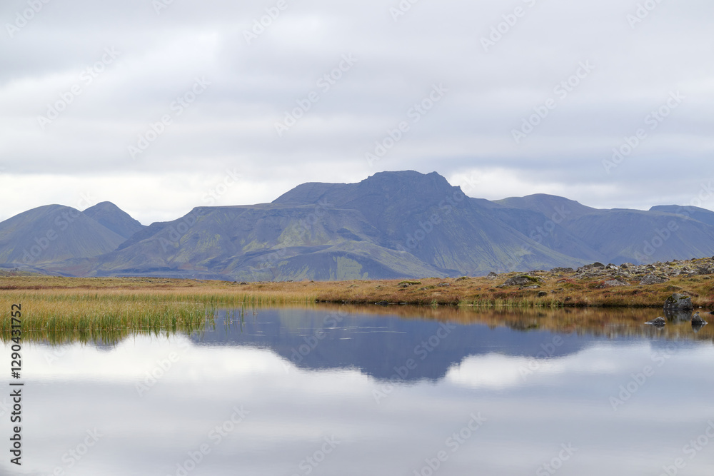 Mountains reflecting in a lake in iceland under cloudy sky Mountains reflecting in a lake in iceland under cloudy sky