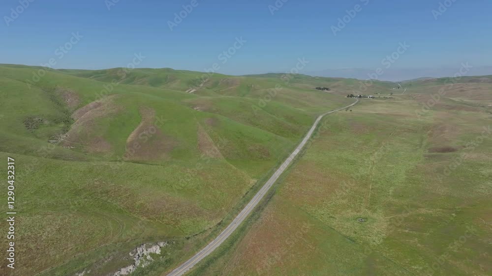 Solitary highway byway cuts through lush green valley Solitary highway byway cuts through lush green valley