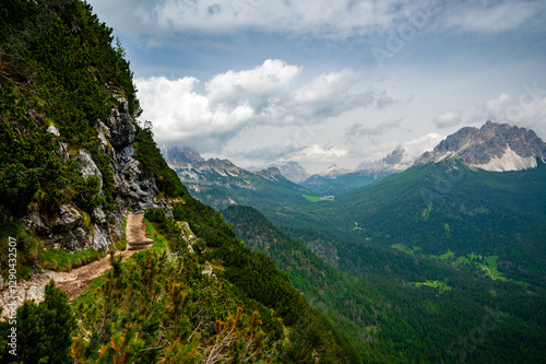 Obraz na płótnie Breathtaking view of forests, mountains, and valleys in the Italian Dolomites (Dolomiti, Dolomiten). Captured from a scenic trail along a rocky ledge. Stunning alpine nature w salonie