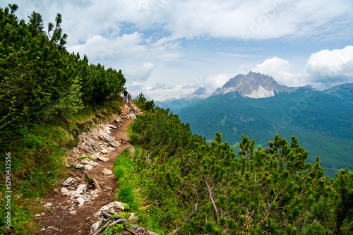 Obraz na płótnie Breathtaking view of forests, mountains, and valleys in the Italian Dolomites (Dolomiti, Dolomiten). Captured from a scenic trail along a rocky ledge. Stunning alpine nature w salonie
