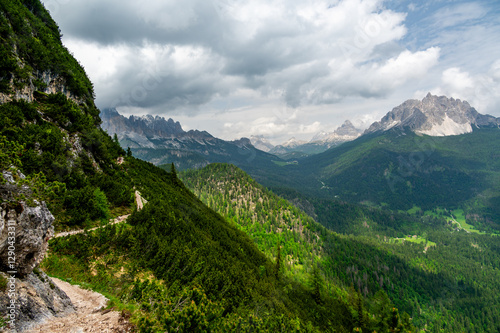 Obraz na płótnie Breathtaking view of forests, mountains, and valleys in the Italian Dolomites (Dolomiti, Dolomiten). Captured from a scenic trail along a rocky ledge. Stunning alpine nature w salonie