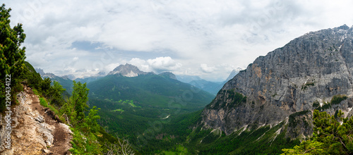 Obraz na płótnie Breathtaking view of forests, mountains, and valleys in the Italian Dolomites (Dolomiti, Dolomiten). Captured from a scenic trail along a rocky ledge. Stunning alpine nature w salonie