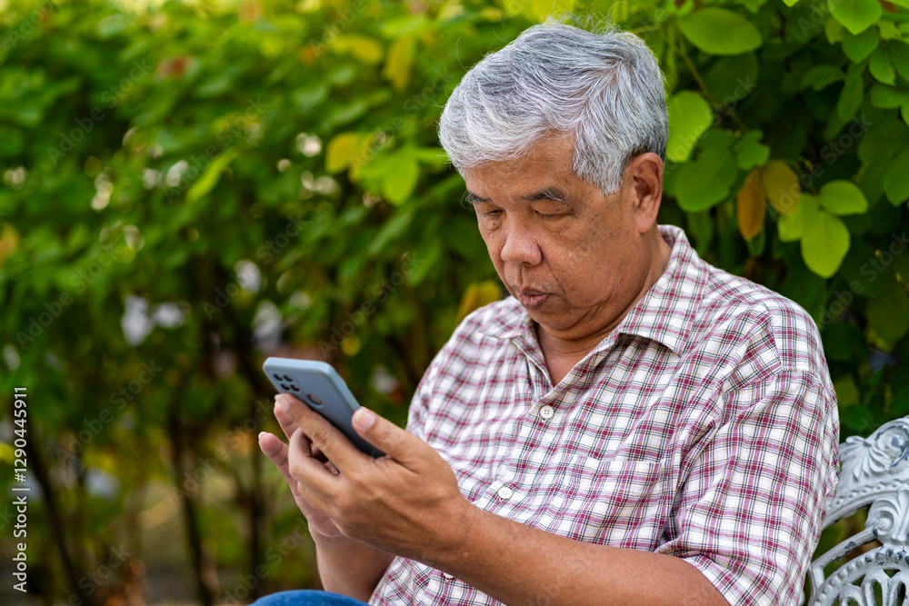 Senior man use smartphone during relax in park Senior man use smartphone during relax in park