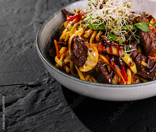 Asian beef stir fry with noodles and vegetables photo