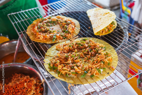 Vietnamese banh Xeo pancakes grilled at an Asian street night market in Vietnam. Traditional Vietnamese street food photo